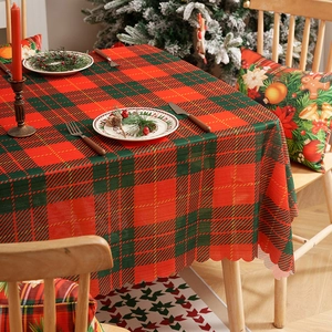 Classic red and green plaid Christmas tablecloth with wavy scalloped edges for festive decor