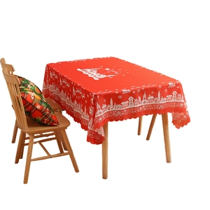 Red Christmas tablecloth with festive white reindeer and snowflake motifs on wooden table