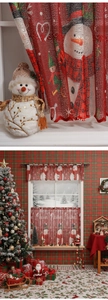 Close-up of semi-transparent Christmas lace curtain with snowman print and Merry Christmas text