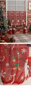 Detail of Christmas cafe curtain featuring festive snowman and elf print on red fabric
