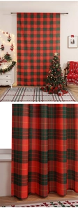 Macro detail showing red and green tartan plaid fabric texture and woven pattern of the curtain
