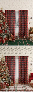 Detail of red and black buffalo plaid Christmas curtains with festive holly leaf patterns