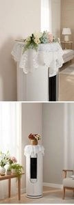 Detail showing white floral lace dust cover with scalloped edges for home appliances