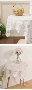 Close-up of white lace dust cover featuring elegant hollow floral embroidery and wavy edges