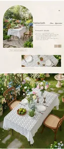 Detail of white floral lace tablecloth showing hollow out pattern in a garden setting