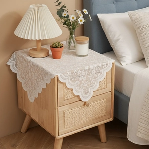 Lace dust cover for nightstand with cream floral embroidery and scalloped edges
