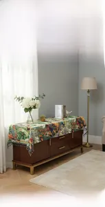 Macro view of vintage floral oil painting table runner with elegant fringe tassels