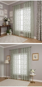 Detail of light green lace sheer curtain with delicate floral embroidery for windows
