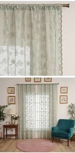 Detail of light green floral lace curtains with scalloped edges and sheer embroidery