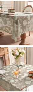Detail of light green lace tablecloth featuring intricate hollow floral embroidery patterns
