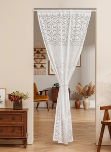 Detailed close-up of white French vintage lace door curtain with floral scroll embroidery