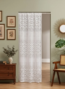 Close-up of white French vintage lace door curtain with intricate scrollwork patterns