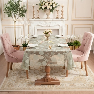 Floral embroidered lace tablecloth in sage green with scalloped edges for dining decor