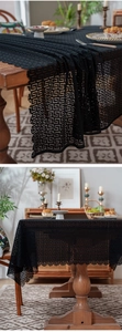 Detailed view of black geometric Greek key lace tablecloth with scalloped edges