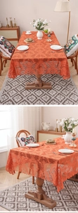 Close-up of orange lace tablecloth featuring damascus floral texture and scalloped edges