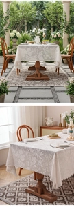 Close-up of white lace rectangular tablecloth with floral textures and wavy edges