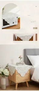Detailed close-up of white lace dust cover with floral embroidery for microwave and bedside tables