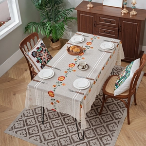 Embroidered floral lace tablecloth in rustic American style on a rectangular dining table