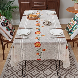 Rectangle beige lace tablecloth with floral embroidery in a rustic home setting