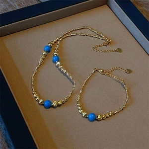 Blue turquoise beaded necklace and bracelet set with heart charms in a luxury box