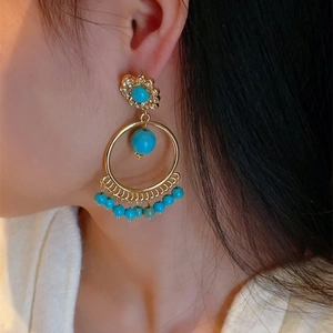 Bohemian 925 silver needle drop earrings with hollow turquoise sphere and gold tassels