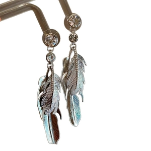 Bohemian silver feather drop earrings with crystal studs on a white background