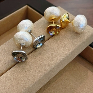 Detailed macro view of square crystal stud earrings with large pearl backings in gold and silver