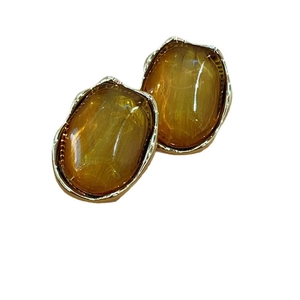 Irregular amber resin oval earrings with gold metal frame and minimalist wave texture