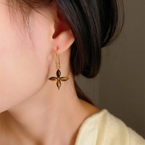 Vintage tiger eye stone flower earrings with gold twisted hoop shown on model