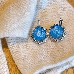 French vintage blue rose drop earrings with crystal rhinestones on white knit background