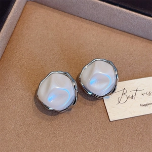Elegant irregular baroque pearl stud earrings with silver wavy metal frames and pearly finish