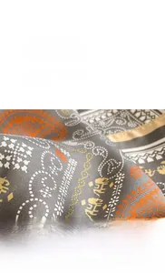 Detailed view of high-density silk twill fabric with vibrant orange and grey paisley patterns