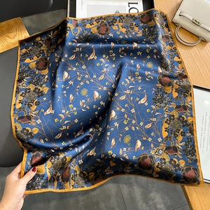 Square silk scarf with navy blue floral and bird prints and gold-orange border