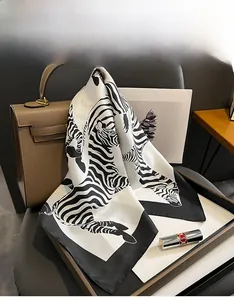 Macro detail of zebra print mulberry silk square scarf with soft texture and black hem