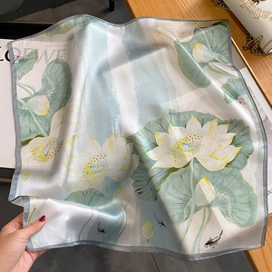 Elegant silk scarf featuring lotus and koi fish patterns with refined grey rolled edges