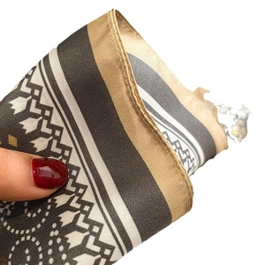 Satin silk scarf with geometric print in black, beige, and gold with fine rolled edges