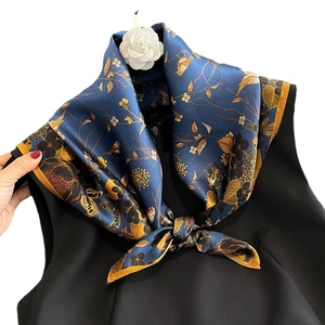 Elegant navy blue silk scarf with golden floral and bird patterns on black top