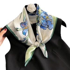 Artistic silk scarf with blue iris oil painting print tied on a chic black top