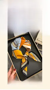 Detailed view of a 70x70cm silk scarf featuring equestrian patterns and twill texture
