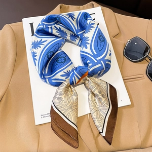 Detail of luxury silk twilly scarf with tropical leaf print and geometric H patterns