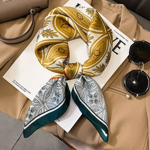 Elegant vintage square silk scarf with geometric clover print styled on a white magazine