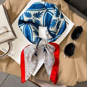 Elegant navy blue and red silk square scarf styled with a khaki blazer and handbag