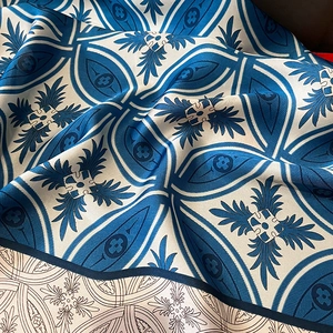 Detailed close-up showing soft silk texture and elegant blue-white geometric patterns