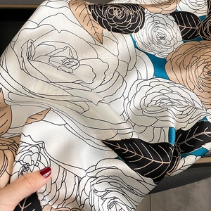 Luxurious satin silk scarf featuring artistic rose prints and champagne gold accents