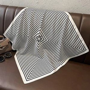 Detailed view of striped satin square scarf texture and geometric pattern design