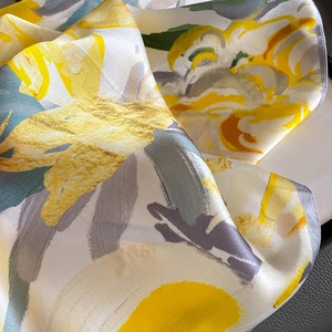 Elegant silk scarf with abstract yellow and grey print and soft draping texture