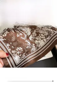 Detailed close-up of fine edge stitching on a brown silk scarf with artistic print