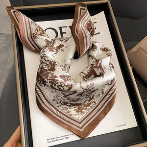 Elegant silk scarf with vintage forest deer print and striped border on a stylist tray