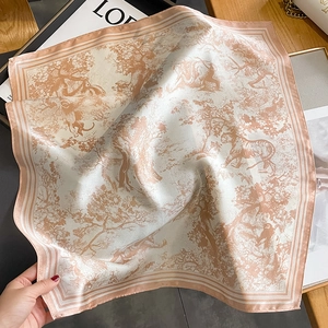 Close-up of a pink Toile de Jouy silk scarf with detailed vintage animal and forest prints