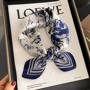 Blue and white Toile de Jouy silk scarf with satin finish on a fashion magazine